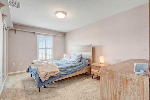 bedroom featuring light carpet