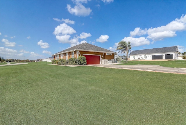 single story home featuring a front yard and a garage