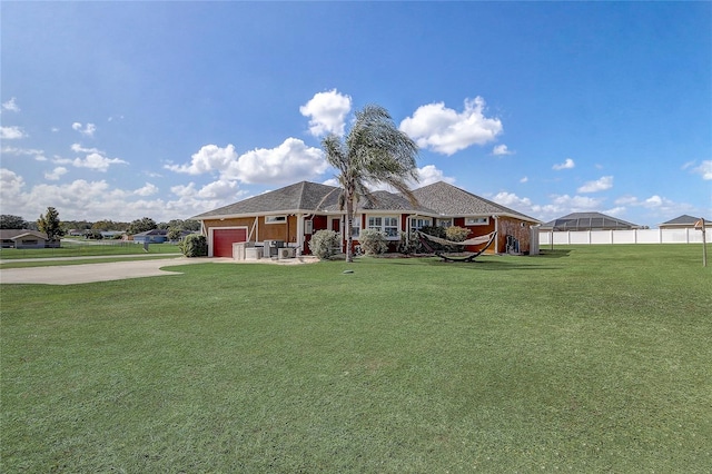 view of front of home featuring a front yard and a garage