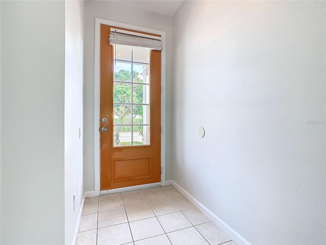 doorway to outside with light tile patterned flooring