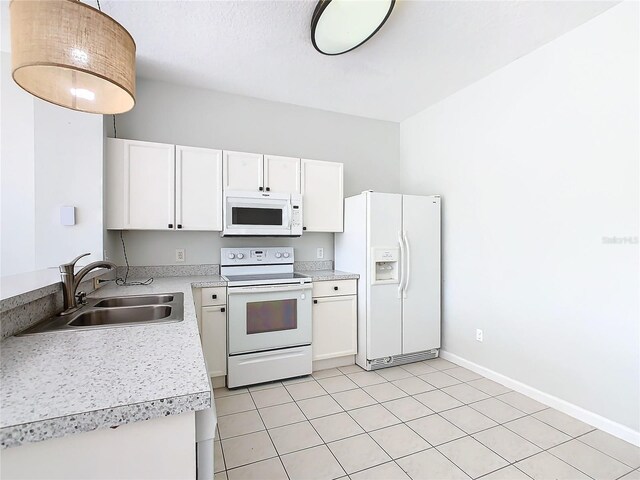 kitchen featuring white cabinetry, white appliances, sink, and light tile patterned floors