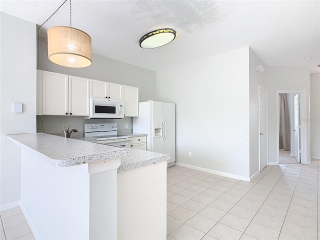 kitchen featuring kitchen peninsula, white appliances, light tile patterned floors, white cabinets, and hanging light fixtures