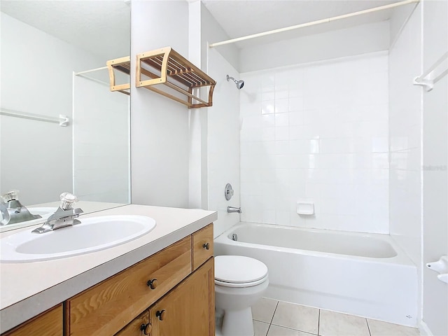 full bathroom featuring tile patterned flooring, vanity, toilet, and tiled shower / bath combo