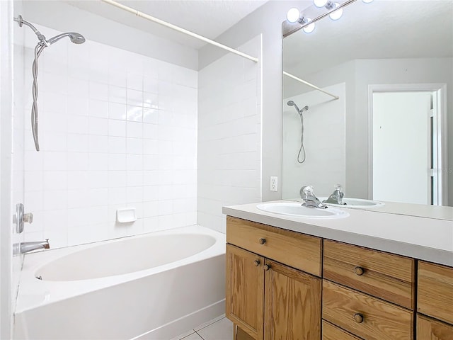 bathroom featuring tile patterned floors, vanity, and tiled shower / bath