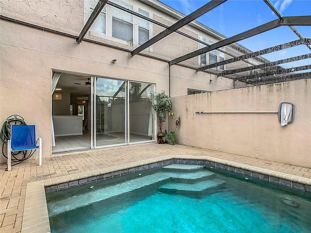 view of swimming pool featuring a lanai and a patio