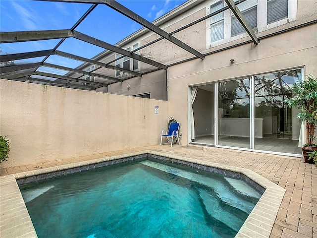 view of pool with a lanai and a patio area