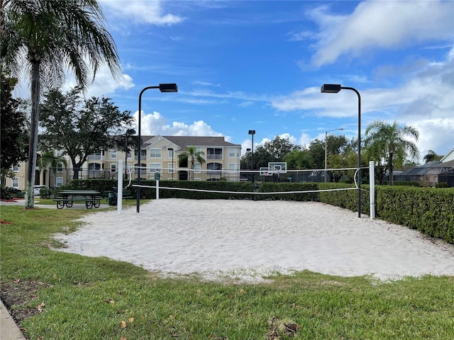 surrounding community featuring a lawn and volleyball court