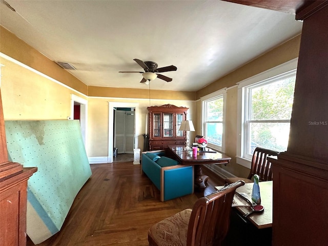 interior space with dark parquet floors and ceiling fan