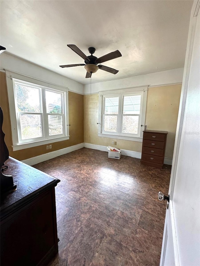 interior space with a wealth of natural light and ceiling fan