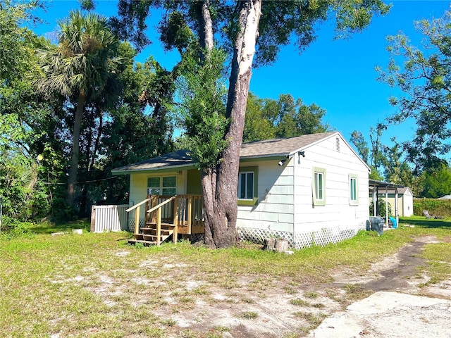 rear view of house featuring a lawn