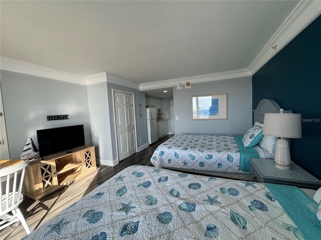 bedroom with white refrigerator, a textured ceiling, crown molding, and dark hardwood / wood-style flooring