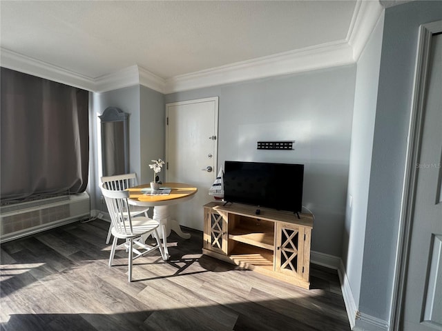 dining area featuring hardwood / wood-style floors and crown molding