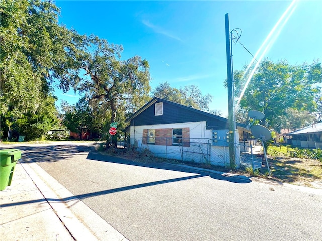 view of front of property with basketball hoop