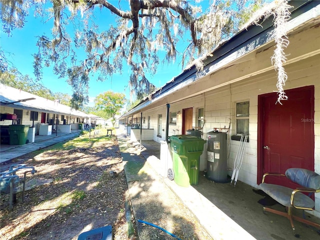 view of side of property featuring electric water heater