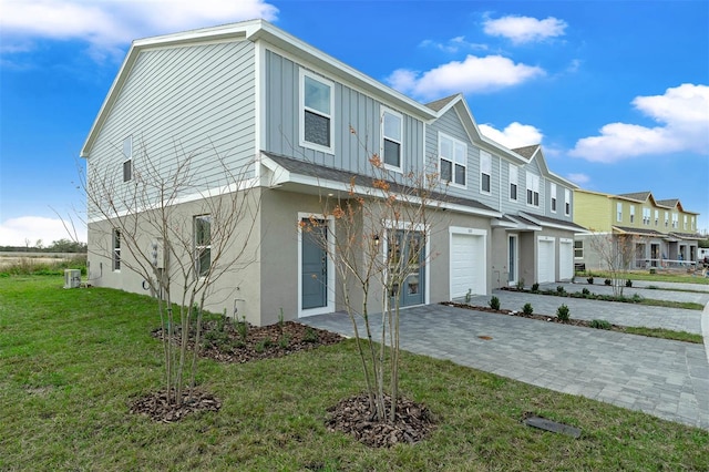 view of front of property with a garage and a front yard