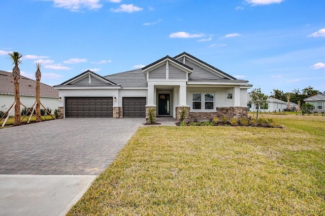 view of front of property with a garage and a front lawn