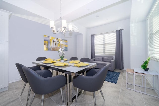 dining room featuring a wealth of natural light and a notable chandelier