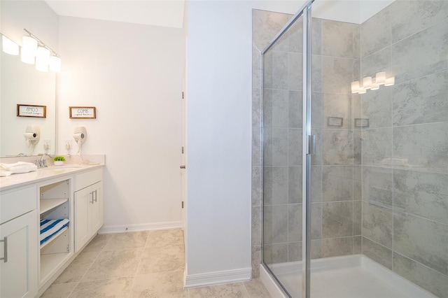 bathroom featuring vanity, a shower with shower door, and tile patterned flooring