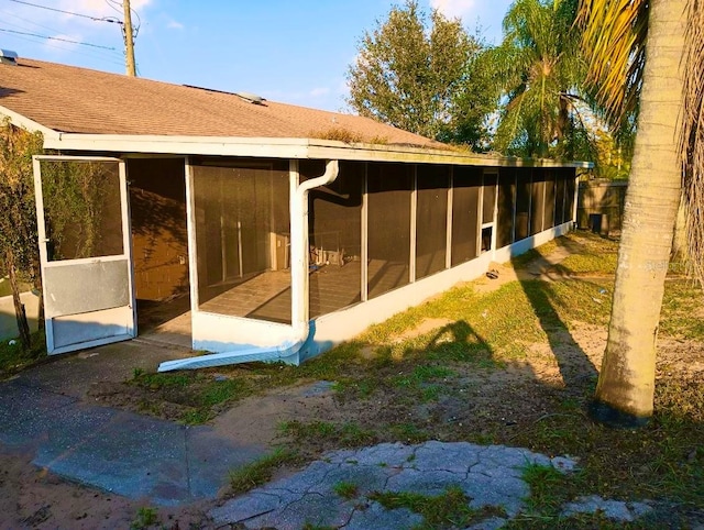 view of home's exterior with a sunroom