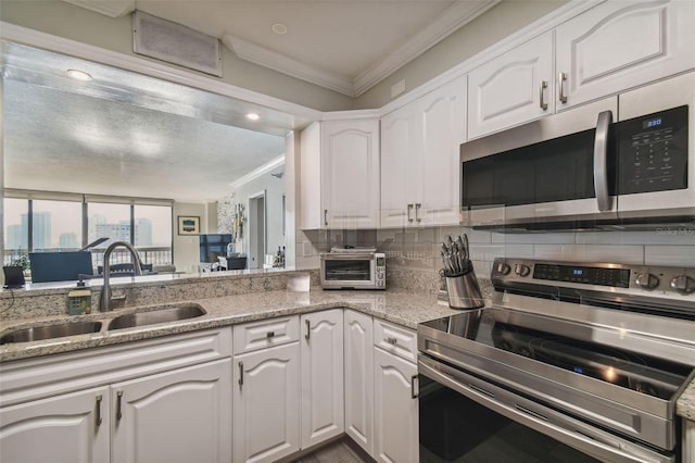 kitchen with white cabinets, stainless steel appliances, and sink