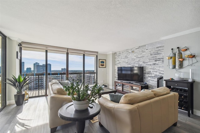 living room with hardwood / wood-style floors, crown molding, and plenty of natural light