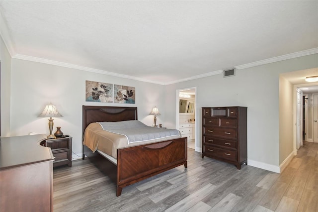 bedroom featuring crown molding, ensuite bathroom, and wood-type flooring