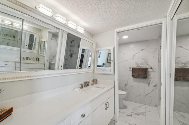 bathroom featuring vanity, toilet, a textured ceiling, and walk in shower