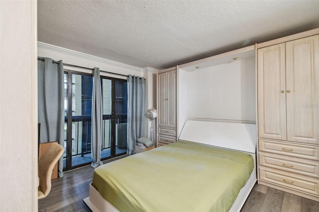 bedroom with dark wood-type flooring, crown molding, access to outside, and a textured ceiling