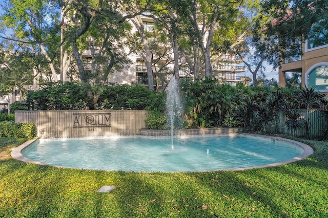 view of pool with a yard