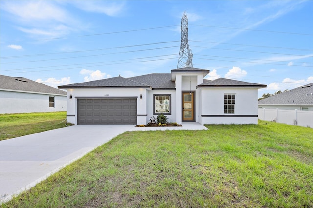 view of front of property with a front lawn and a garage