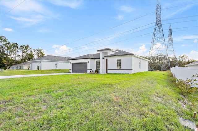 view of front of home featuring a front lawn and a garage