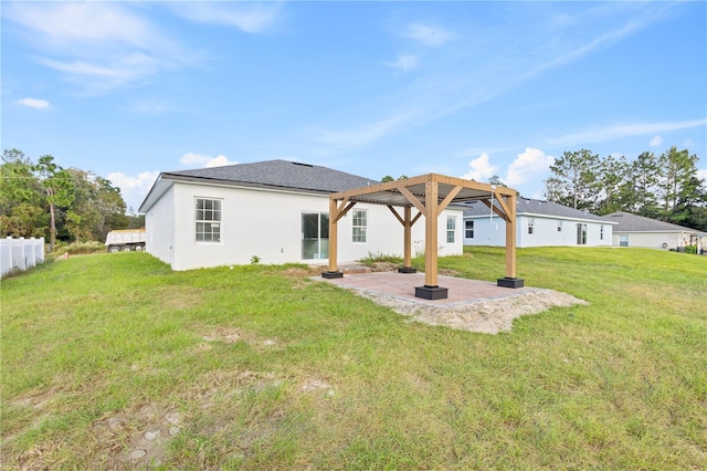 rear view of property featuring a patio area and a lawn