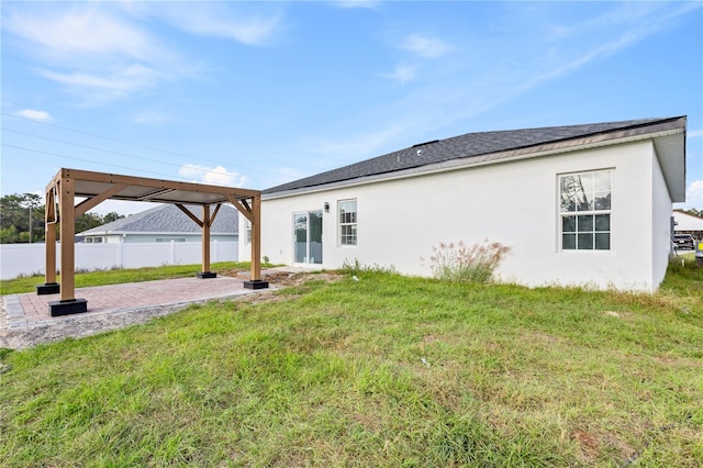 rear view of house with a patio and a yard