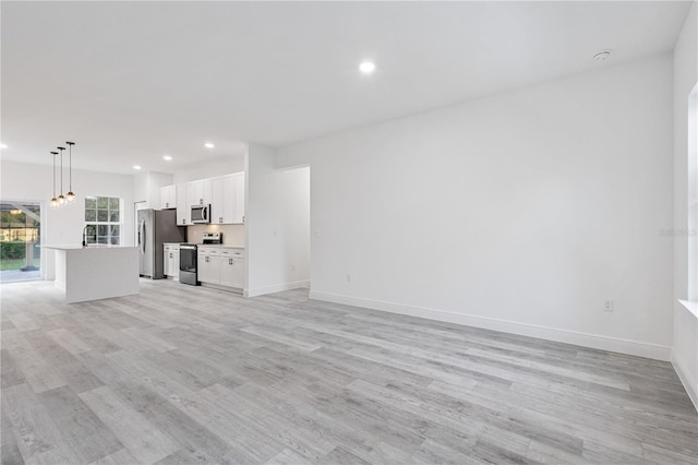 unfurnished living room with light wood-type flooring