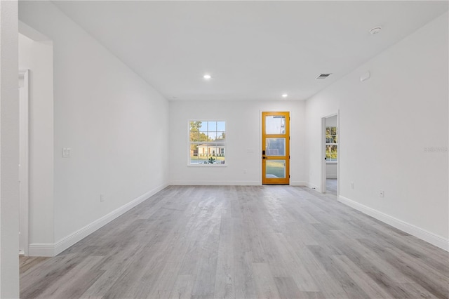 spare room featuring light wood-type flooring