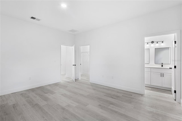 spare room with light hardwood / wood-style floors