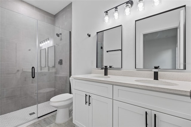 bathroom featuring vanity, hardwood / wood-style floors, toilet, and walk in shower