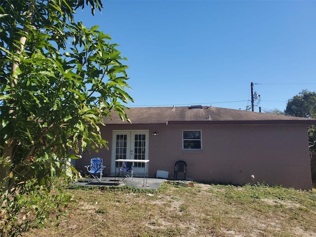 back of house with french doors, a yard, and a patio