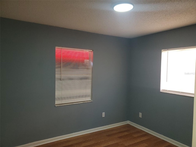 unfurnished room with wood-type flooring