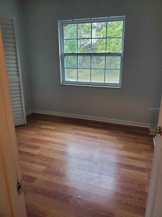 interior space with baseboards and wood finished floors