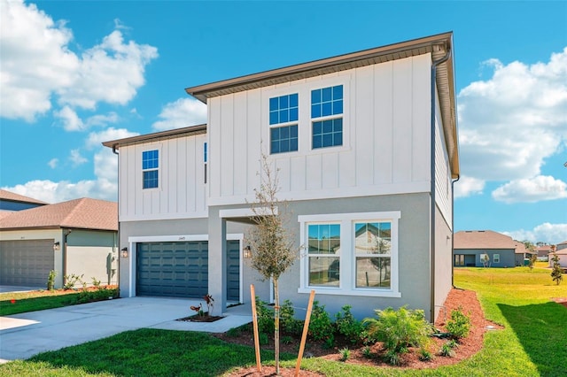 view of front of house featuring an attached garage, board and batten siding, concrete driveway, and a front yard