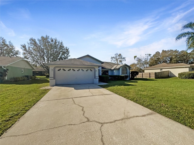 ranch-style house featuring a front yard and a garage