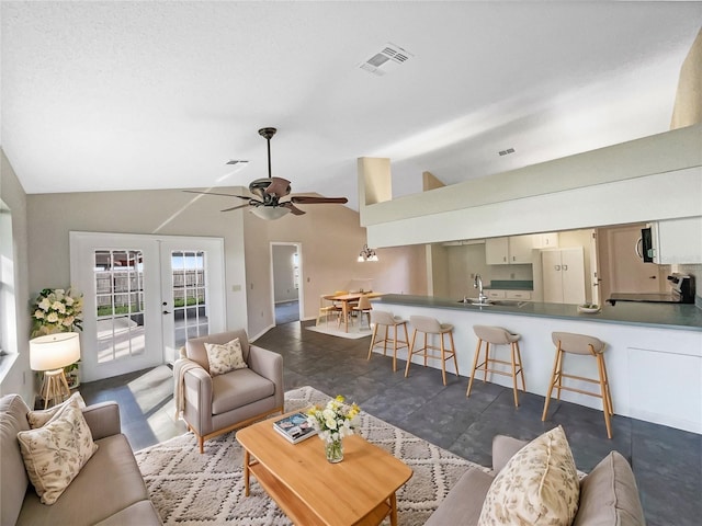 living room with french doors, ceiling fan, high vaulted ceiling, and sink