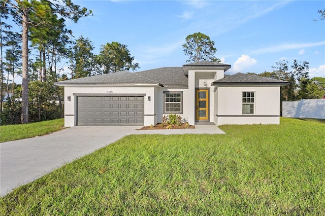 view of front of house with a garage and a front lawn