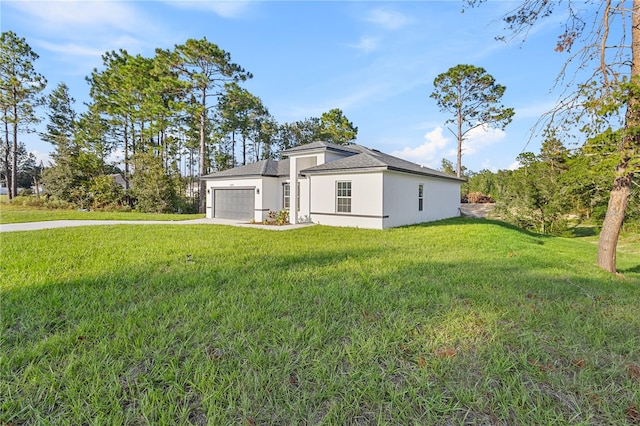 view of side of home featuring a lawn and a garage