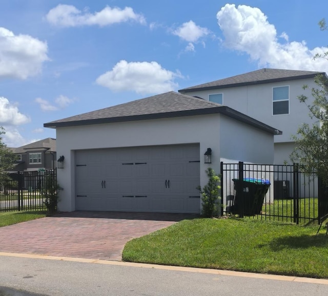 12500 Encore At Ovation Way, Winter Garden, FL 34787 - view of front of property with stucco siding, decorative driveway, an attached garage, and a shingled roof
