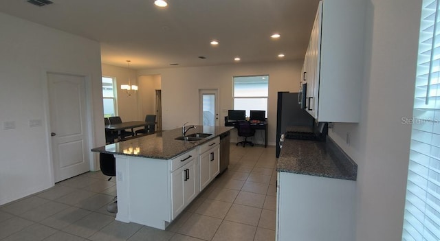 12500 Encore At Ovation Way, Winter Garden, FL 34787 - kitchen featuring an island with sink, a chandelier, dark stone countertops, light tile patterned floors, and white cabinetry