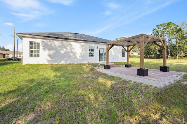 back of house featuring a gazebo, a patio area, and a lawn