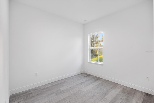 empty room with light hardwood / wood-style flooring