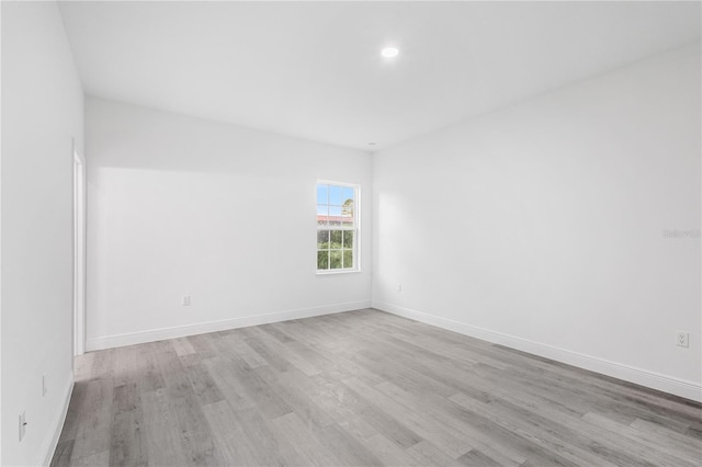 spare room with light hardwood / wood-style flooring